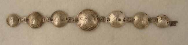 Rare Coin Silver Bracelet 7 Philippine Coins 1945 WWII: This vintage bracelet was hand made with silver coins from the Philippines, and it's unique because the spacers have letters that spell out MANILA, 1945. Also, the largest coins is engraved "To Jane."