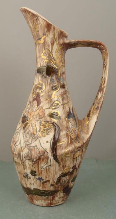 Asian Ewer Hand Painted Gilt Pottery Pitcher: This is a ewer, hand etched and painted with Asian or Arabian figures and landscape. It is marked on the bottom, and we believe this vase is Chinese, dating back over 40 years. It measures 13 1/4" hig