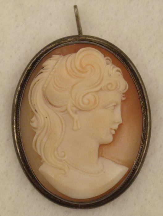 Sterling Carved Shell Cameo Brooch Pendant Old Mexico: This sterling silver carved cameo can be worn as a pendant or a brooch. The cameo lady has beautiful swirling hair. The silver setting has a pin marked 800, and the back of the shell has a name acid e