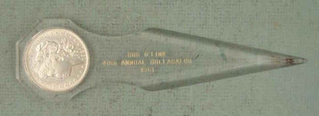 1921 Unc Morgan Silver Dollar Souvenir Letter Opener: This 1921 S Morgan Silver Dollar was made into a commemorative letter opener. It is dated 1961, celebrating the 40th annual "Hullabaloo." It is clear Lucite, 6 1/2" long, with wear at the end. It is i