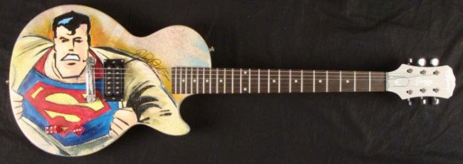 Duerrstein Orig Painted Superman Superhero Guitar: This mild-mannered Epiphone Gibson electric guitar has been transformed into a super-heroic instrument. It's a real guitar, it's hand-painted, it's Superman! This one and only original guitar was crea