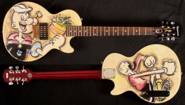 Duerrstein Original Painted Popeye Cartoon Art Guitar: Get yourself an amp and a can of spinach-- this hand painted Popeye electric guitar really packs a wallop! This one and only original guitar was created by artist Dick Duerrstein, who has lots of expe