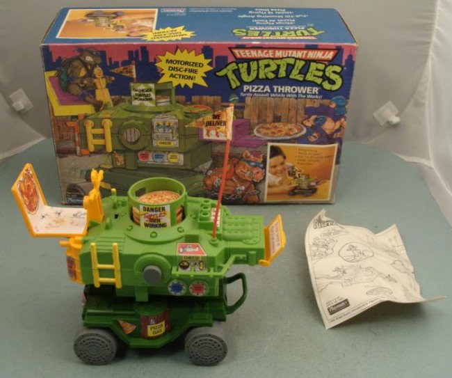 TMNT Turtles Pizza Shooter Vehicle Working IN BOX: Here is the turtle assault vehicle with the works: it's the Pizza Shooter. This model was tested to be in excellent and working condition, and boy those pizzas really fly! It comes with 10 pies, and y