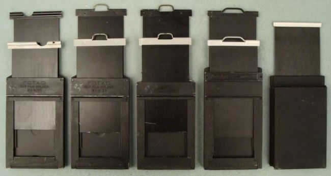 5 Film Holders for a Mini 2 1/4 x 3 1/4 Camera Graflex: Here are 5 Cut Film Holders for a Mini 2 1/4 x 3 1/4 Camera. One is for paper negatives, and has a hinged door that opens. The other four have two slides each. Two are Fotac, one is a Graflex Type 5,