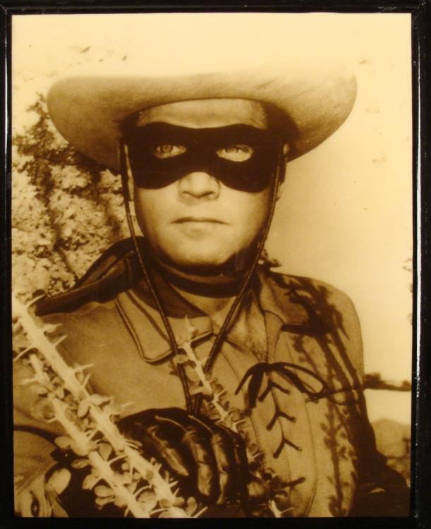 Lone Ranger B & W Laminated 11 x 14 Photo Plaque: This 11 x 14 black & white photo has been lamintated on a backing board, and its sepia tone gives it an antique look. The board is painted black, with rustic rough edges, and measures 11 3/4" x 14