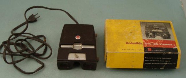 Kodaslide Stereo Viewer 1 for 3-D Photos In Box: This Kodalide Stereo Viewer 1 is designed for viewing any standard stereo slide. It is working, and just needs some cleaning. It also comes in the original box, which has some wear. The viewer plugs i