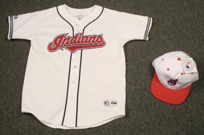 Cleveland Indians Youth Vintage Jersey Baseball Hat: Offered here is a Cleveland Indians jersey and baseball hat. The jersey is a white, all-season youth large from Majestic. There is some minor stains on the jersey. The hat is al