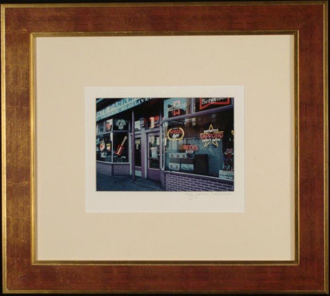 Mary Jeanne Lawrence Neon Beer Sign Photograph Framed: This photograph shows the storefront window of a neon sign distributer, full of glowing neon beer signs. Medium: Photograph Photographer: Mary Jeanne Lawrence Signature: Signed in pencil, lower right 
