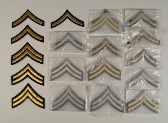 27) VINTAGE MILITARY CHEVRONS: THESE ARE VERY HIGH QUALITY, LARGE MILITARY CHEVRONS. MOST OF THEM ARE STILL IN THEIR ORIGINAL PACKAGING. 18 OF THEM ARE SETS OF ONE AND TWO CHEVRONS IN GOLD BULLION ON