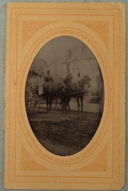 Antique Tintype Photo Horse & Buggy -African American: This antique tintype photograph portrays a horse and buggy on a road outside a large house. There are 3 lady passengers, and a moustached man in a top hat. This is the driver, and he is African Americ