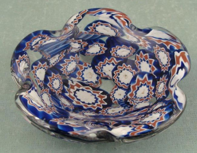 Hand Made Italian Murano Art Glass Bowl Dish: This art glass dish is Italian, with a Murano style. It is red, white and blue star pattern canes in clear glass formed in a flower shape. It measures 5 1/2" x 1 1/2". You may notice a couple cracks i
