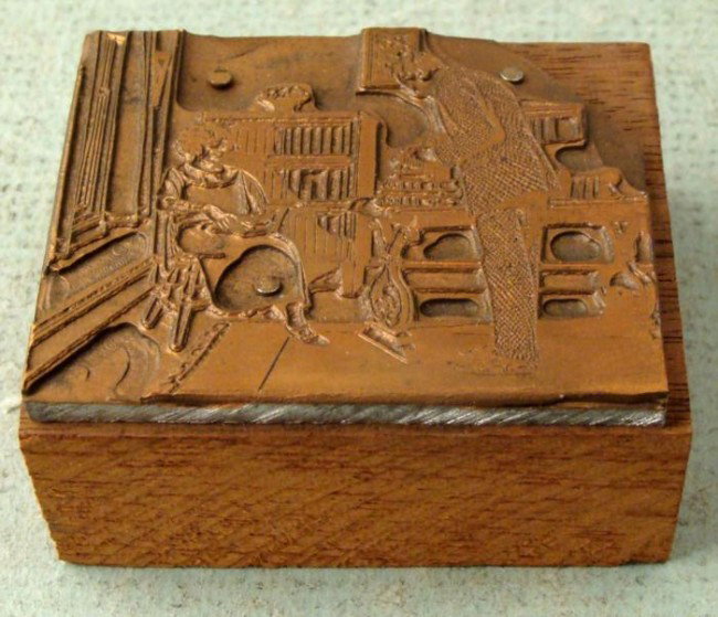 Kodak Camera Old Ad Copper Printer Block 1920s: This copper printers block was made for a print ad for Kodak cameras. It portrays a lady seated in a chair by a bookcase, and a man with a camera taking her picture. The block measures up to 1 3/4" x 