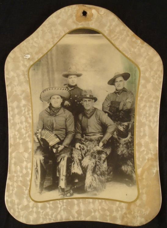 Antique Cowboy Band Photo in Unique Frame: This antique photograph is a portrait of a band of cowboys, or a cowboy band. One wearing a Mexican hat holds an accordion. The others have felt cowboy hats, with warm fur pants. One holds a gun. The 