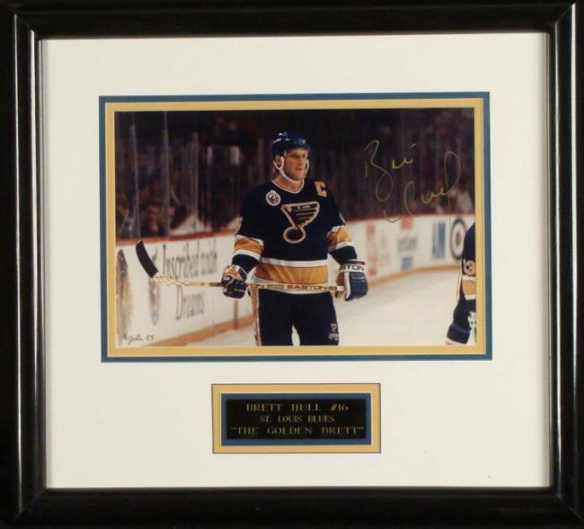 Brett Hull St. Louis Blues Signed Framed Photo w/ COA: This framed photo was signed by "The Golden Brett," Brett Hull, appropriately enough in gold paint pen. The black engraved black pays tribute to his nickname, and his number with