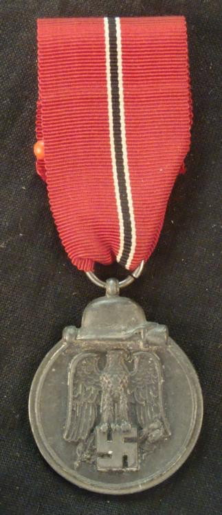 ORIGINAL 1941/42 NAZI RUSSIAN FRONT MEDAL FULL RIBBON: HERE IS A NEAR MINT ORIGINAL NAZI RUSSIAN FRONT MEDAL & FULL RIBBON--MOSTEN FROM 1941/42. THERE IS AN EAGLE ON SWASTIKA & ABOVE IT IS A POTATOMASHER & HELMET. ON THE REVERSE IT 
