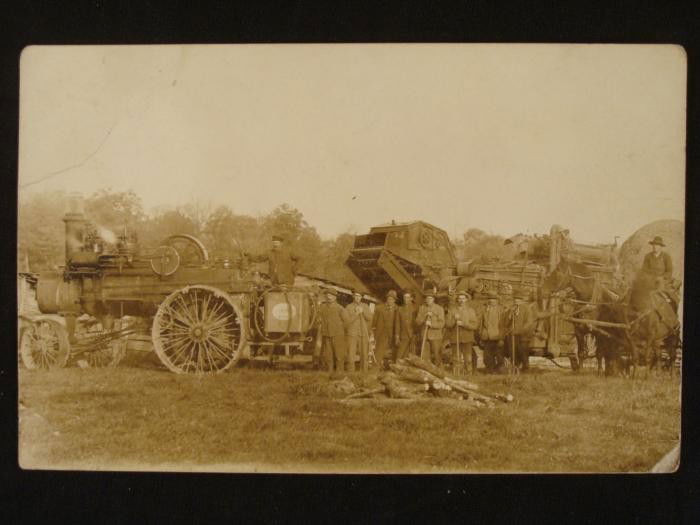 Antique Real Photo Postcard Steam Powered Machinery: This original real photo postcard portrays some type of steam powered vehicle and machinery, along with a horse and cart. It is in very good condition, with a slight crease on the upper left corner.&n