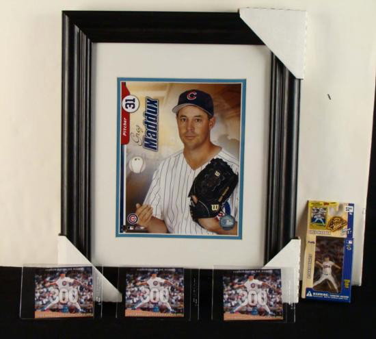 Greg Maddux Chicago Cubs- Figurine Framed Photo Cards: This is a very nice lot of Greg Maddux memorabilia. The framed photo is of Greg Maddux, a pitcher who played for the Chicago Cubs. In the photo he is tossing up a baseball. The 