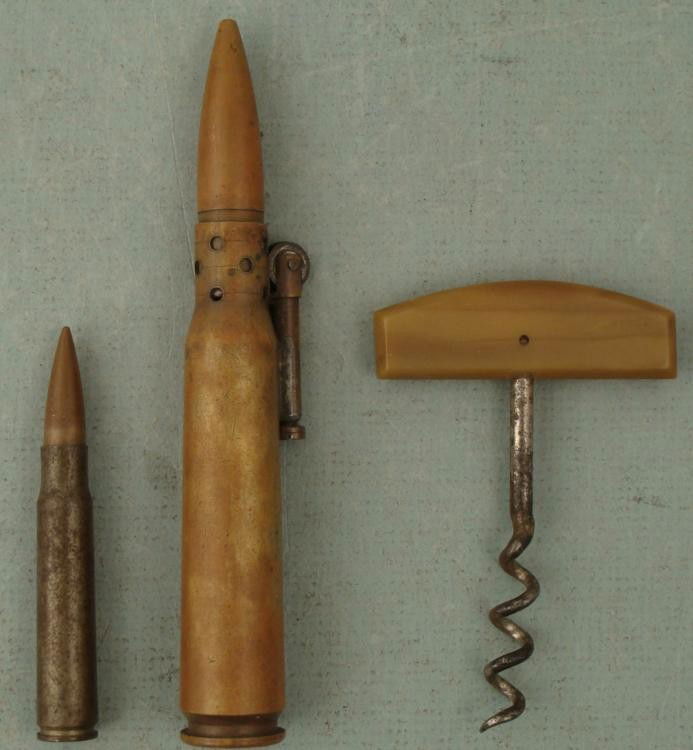 WWII Bullet Lighter, Bullet, & Corkscrew World War II: WWII Bullet Lighter, Bullet, & Corkscrew * Condition: Very good (some wear) Size of bullet lighter: 5 1/2" Size of bullet: 3" Size of corkscrew: 3" Lighter is untested Lighter marked DM 43