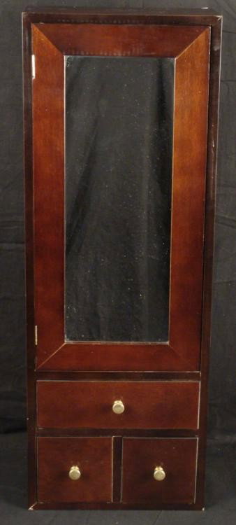 Mirrored Wall Cabinet Mahogany Wood w/ Drawers: This is a mirrored cabinet that mounts on the wall. The size is 10 1/4" x 4 3/4" x 28 1/2". It is mahogany finish wood, with three drawers, and hinged mirrored door with spring/magnetic closure. It op