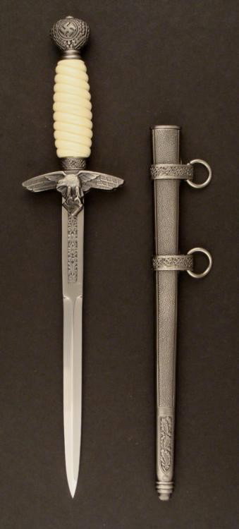 NAZI LUFTWAFFE DAGGER POST WAR COPY ENGRAVING ON BLADE: NAZI LUFTWAFFE DAGGER W/ENGRAVING ON BLADE, POST WAR COPY, WELL MADE. THIS IS A NICE OLDER COPY OF A NAZI LUFTWAFFE DAGGER. IT HAS A POMMEL BAL WITH SWASTIKAS. THE CROSSGUARD HAS EAG