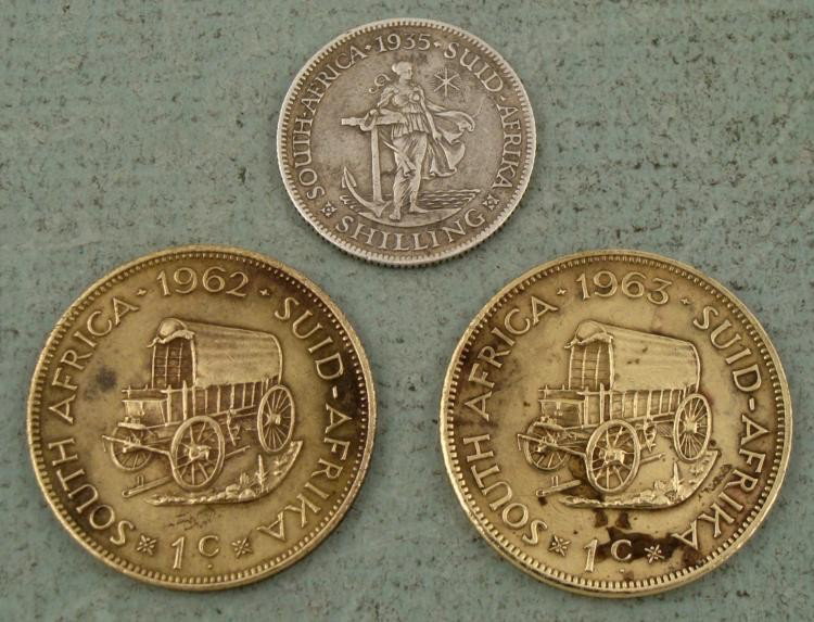 3 South African Coins 1935 1 Shilling 1962-63 1 Penny: Offered here are three South African coins. In this lot you will receive: * 1935 One Shilling (Silver)1962 and 1963 One Penny *