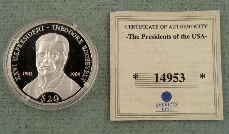 Large Liberia .999 Silver 20 Gram Commemorative Coin: Here is a large 2000 Liberia .999 Silver, 20 gram commemorative coin. On one side is President Theodore Roosevelt (1901-09) and the other is the Republic of Liberia, with an island, ship, sunset