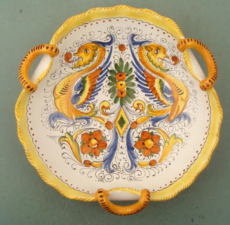 Deruta Italy Italian Majolica Hand Painted Pottery Bowl: This is an Italian Majolica Hand Painted Pottery Bowl from Deruta Italy. This is a serving bowl, with three curved rope handles, 12" in diameter. The pattern features two fantastic creatures, all in b