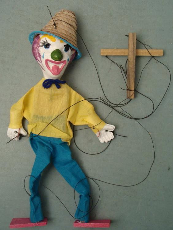 Clown Marionette 14" Ceramic Head & Cloth Body Vintage: This smiling Clown Marionette is vintage, and he's ready to do a dance for you. * * Condition: Very GoodSize: 14" tallComposition: Ceramic head with natural woven hat, cloth body and wooden feet