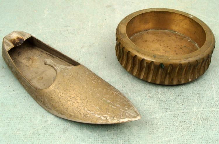 2 Vintage Cigarette/Cigar Ashtrays Shoe India: Here are two vintage ashtrays. One is for cigars. It is in the form of a shoe, with nice designs, about 7" long and made in India. The other is a heavy brass, with gear-like grooves around the sides,