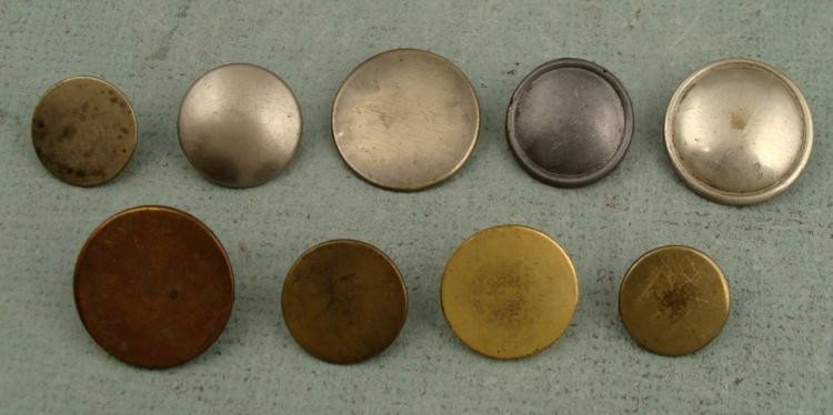 9 Colonial Era Coat Buttons Gilt & Pewter Tone: 9 U.S. Colonial Era Coat Buttons in both flat and rounded styles. * Composition: Pewter and gold colored, and some with brass shanksDiameter: 3/4" to 1"Markings: ROGERS PEET & CO., NY, WARRANTED O