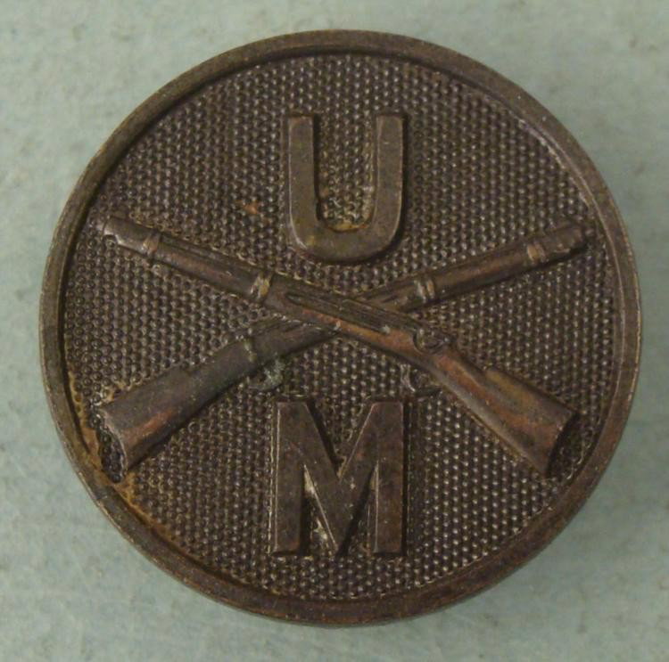WWI U of M U.S. Military Collar Insignia Disk: This is an original WW I era Collar Disk. It is marked U M (U of M?), with crossed rifles, and dotted background. The diameter is approximately 1 inch. It is in excellent condition. * This will be goo