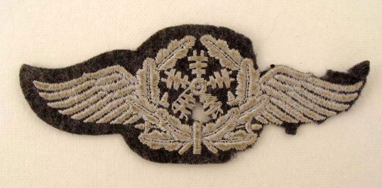 ORIGINAL NAZI LUFTWAFFE SPECIALTY INSIGNIA BADGE: OFFERED HERE IS AN ORIGINAL NAZI LUFTWAFFE SPECIALTY INSIGNIA BADGE FOR FLYING TECHNICAL PERSONNEL. THE MATERIAL IS A BLUE/GREY WOOL AND IT IS EMBROIDERED. 