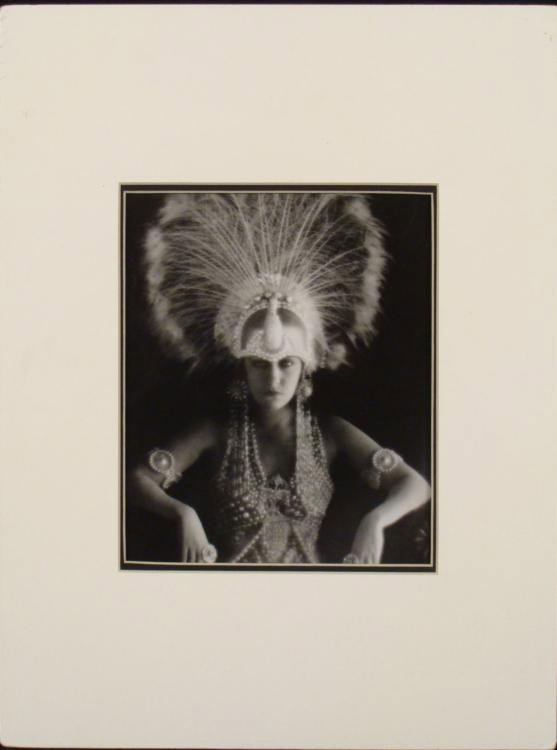 Gloria Swanson Art Deco Photo Print Edward Weston: This is a photographic print of the famous silent screen star Gloria Swanson, shown here circa 1920's in an Art Deco feather and bead costume. * Medium: Print on paperDate produced: 1993Edition: Edwar