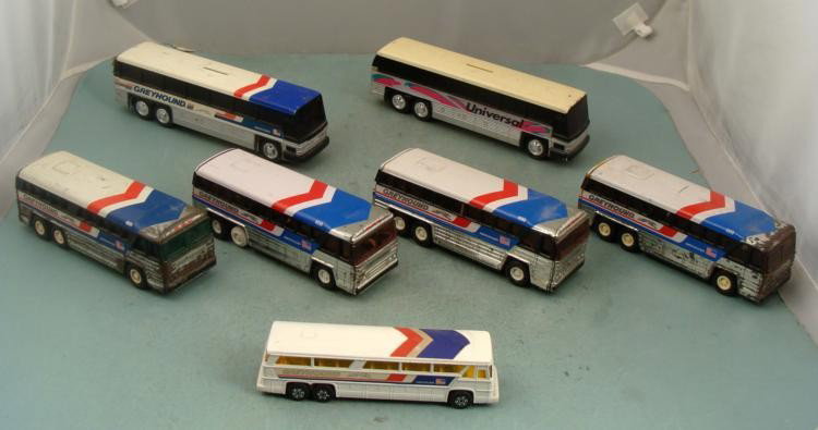 Seven Vintage Buses Die Cast Bank Greyhound Universal: The revolution of the bus service over the years has made transportation for the entire world more feasible and convenient. Offered here are six Greyhound buses and one Universal bus ("piggy ban