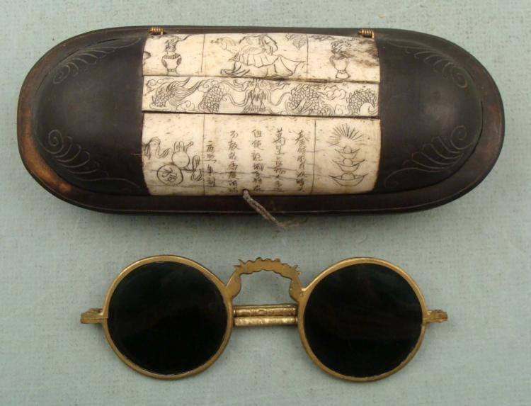 Vintage Chinese Glasses Case w/ Folding Sunglasses: Here is a pair of sunglasses and a glasses case, both vintage Chinese made. The glasses are brass rack frame folding style, with gray tinted lens. The measure 5 1/4" wide, with 1 3/4" diameter lens. T