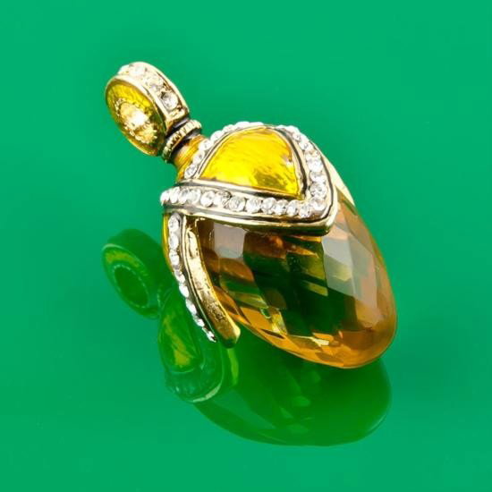 Waterdrop Faberge Pendant: Waterdrop Faberge Pendant. Golden colored gem is attached to an yellow enameled holder covered wtih miniature crystals at the edges. The oval central stone within a border of crystals is surmounted by