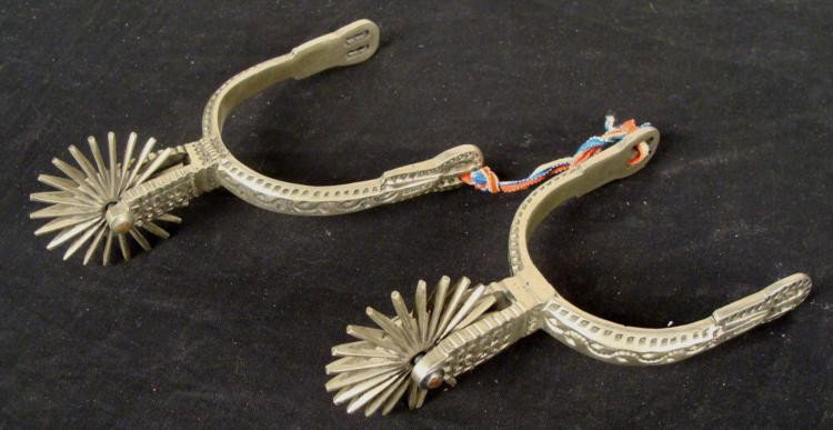 Vintage Cowboy Spurs Pewter Tone Metal Made in Chile: Here are a pair of vintage cowboy spurs. They were made in Chile, are very decorative and were made out a pewter tone metal. The back wheels still turn very easily. The diameter of t