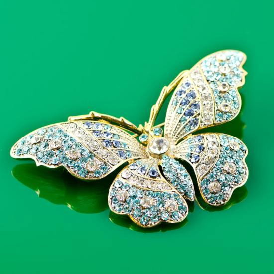 Faberge Butterfly Brooch: Faberge Butterfly Brooch, Dimensions: 2.5in (W) x 1.5in (L), Material: Pewter, Crystals. The brooch is an absolute sparkling beauty with colored crystals all over.