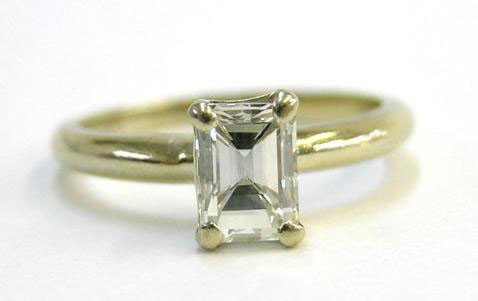 Tiffany Solitare Diamond Ring: 14K White Gold Ring. One carat emerald cut diamond in a Tiffany mount. Ring size 5, Underside of mounting modified to allow space for wedding band. Mwf1903