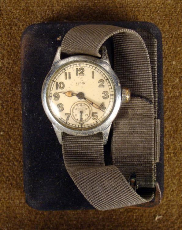WWII ERA ELGIN WRIST WATCH IN CASE: THIS IS A WWII ERA ELGIN WRIST WATCH. THE WATCH WORKS BUT NEEDS A CLEANING; IT COMES IN A BLACK CASE. * *