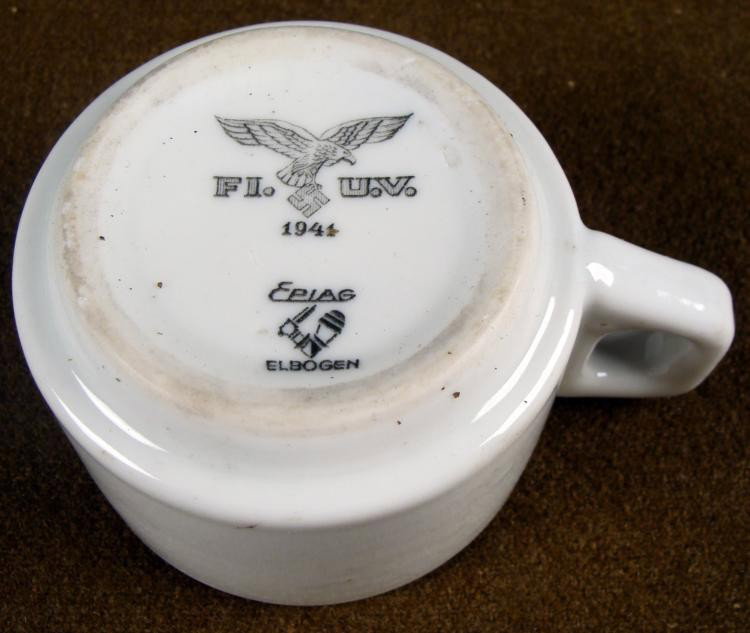 1941 ORIGINAL LUFTWAFFE DININ HALL COFFE CUP: HERE IS A 1941 LUFTWAFFE ORIGINAL DINING HALL COFFEE CUP. ON THE BOTTOM OF THE MUG THERE IS A LARGE NAZI LUFTWAFFE EAGLE CLUTCHING A SWASTIKA. IN BETWEEN THE EAGLE IT IS MARKED FI. U.V.&nb