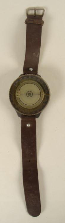 Rusian Paratrooper Compass Watch Russia: This is a Russian Paratrooper Compass Watch. It features a rotating bezel with arrow above a black ring of white numbers. The plastic has normal yellowing. The back has a red line, and the letters sbe