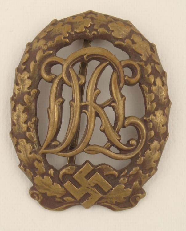ORIGINAL NAZI "SA" DRL SPORTS BADGE WITH SWASTIKA: OFFERED HERE IS AN ORIGINAL NAZI "SA" DRL SPROTS BADGE WITH SWASTIKA. ITS MAKER MARK READS: WERNSTEIN-JENA. ON THE REVERSE, THE BOTTOM CATCH IS NOT PRESENT. *