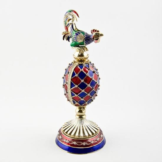 Rooster Clock Faberge Egg: Rooster Clock Faberge Egg. Material: Pewter, Crystals, Enamel. Dimensions: 6.5in (H) X 2.5in (Base Diameter) 1.75in (Egg Diameter) The famed Faberge eggs are jeweled eggs, often with the m