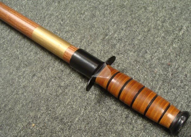 WEAPON WOOD CANE: THIS IS A WEAPON WOOD CANE WITH A HEAVILY WEIGHTED TOP PORTION. IT IS 42" LONG AND WELL MADE. * * *