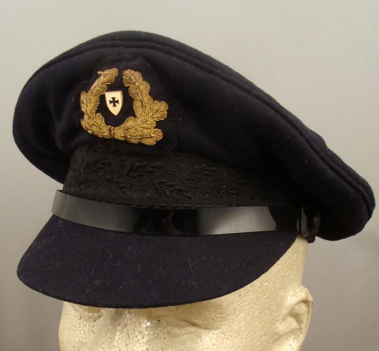 WWII Nazi German Navy Cap with Buttons: WWII Nazi German Navy Cap with Buttons * Exterior: Black felt with embroidered black oak leaves, gold threaded front, with iron cross pin. Interior: K Graf Luckner Mutze maker, yellow silk top, leathe