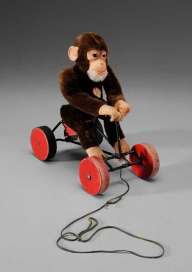 MWF1307 Steiff Monkey Pull Toy German/Austrian early 2: MWF1307 Steiff Monkey Pull Toy German/Austrian, early 20th century, fabric body with wire frame and wooden wheels, monkey rises as it is pulled, original necklace label and ear label f