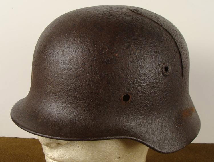 WWII M40 NAZI COMBAT HELMET REMAINS FRM KOURLAND POCKET: WWII M40 NAZI COMBAT HELMET REMAINS FROM KOURLAND POCKET * RE-PAINTED--SHOWS ARTILLERY SHELL HOLE AND FRACTURE FROM IMPACT *