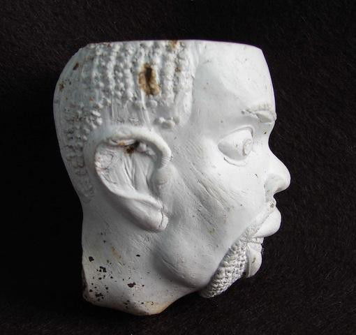 Early Clay Pipe depicting the head of Southern Slave: Early Clay Pipe depicting the head of Southern Slave during the 1840 to 1860 period. This pipe was unearthed at a tavern site in South Carolina and were most probably cast in the south and given to bi