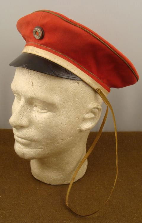 WWI German Military School Cap Red Wool: This is a WWI era German Military School Cap. It is red wool, with leather sweat band, white rim, black brim, gold strap, and light blue silk lining. No size is marked, but it is about 20" around on t